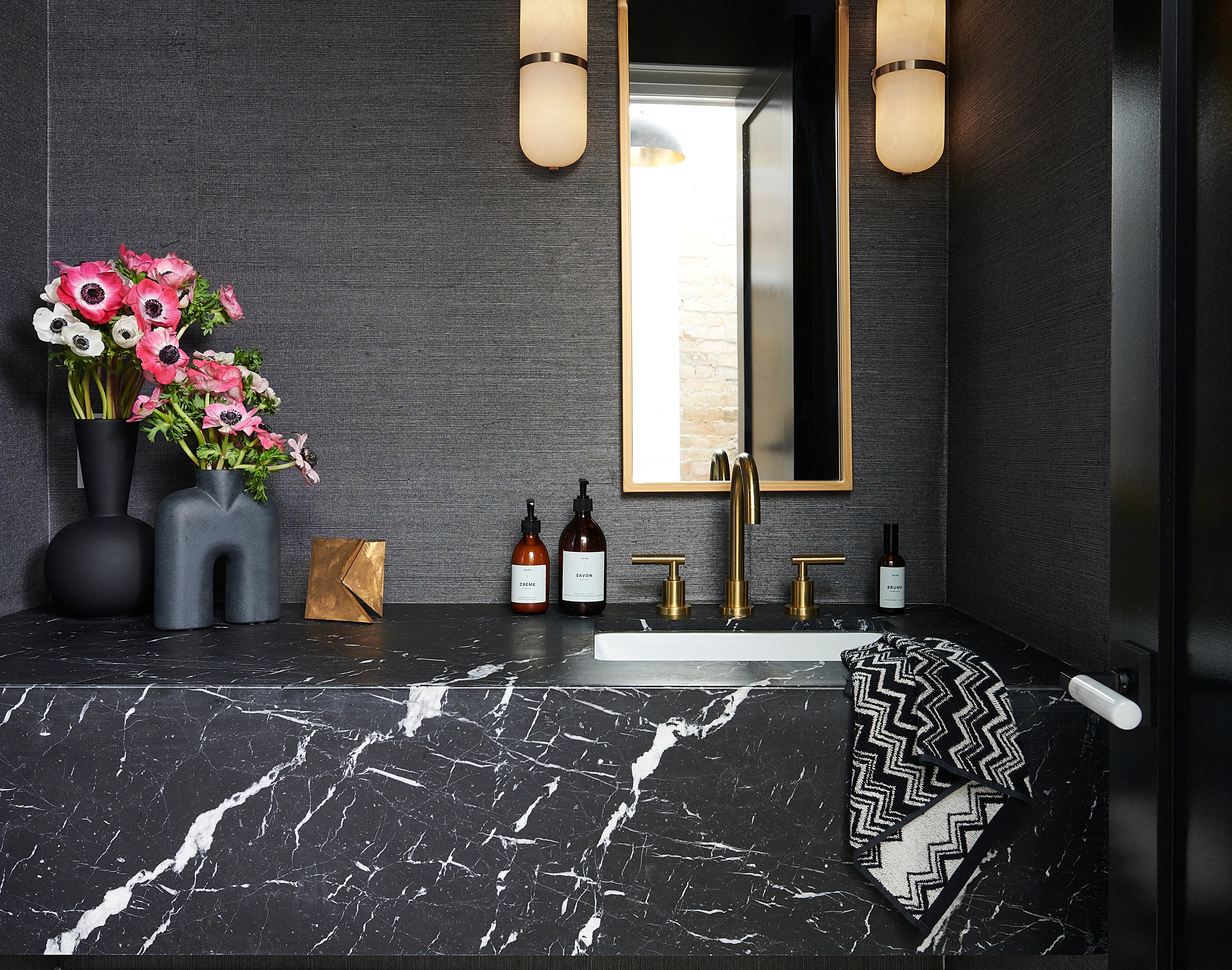 powder room, marble floor, missoni, flowers, brass accents, textured wallpaper, marble vanity