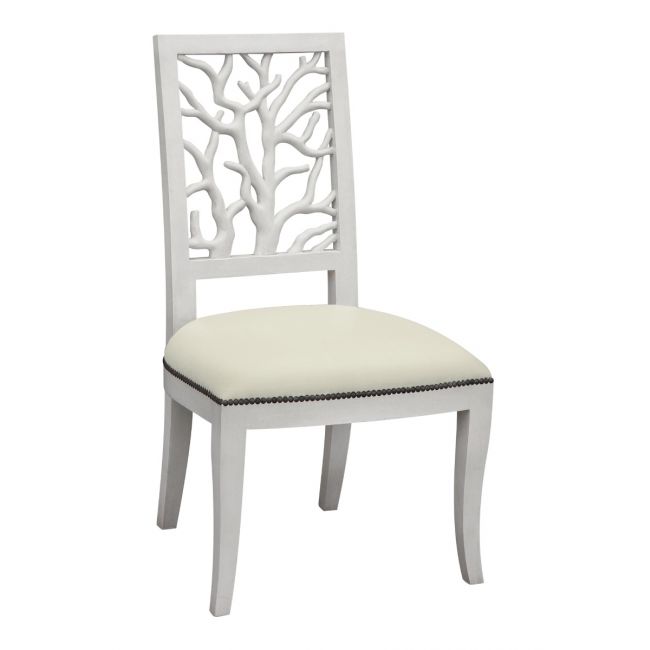 Coral white dining chair with upholstered seat and white wash wood legs with brass studs