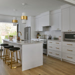 Transitional home white kitchen with brass hardware faucet and accents with black pony fur counter stool contemporary lighting