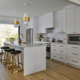 Transitional home white kitchen with brass hardware faucet and accents with black pony fur counter stool contemporary lighting