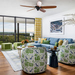 Colourful home with canvas palm tree pattern colourful blue green and jute rug overlooking ocean