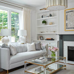 Elegant and sophisticated living room with feminine decor accents in brass and acrylic