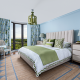 Naples Florida bedroom with blue and green Mattock scallop bedding and jute rug with scallop edge